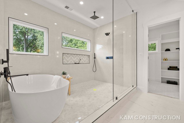Primary bathroom with freestanding tub and glass walk-in shower