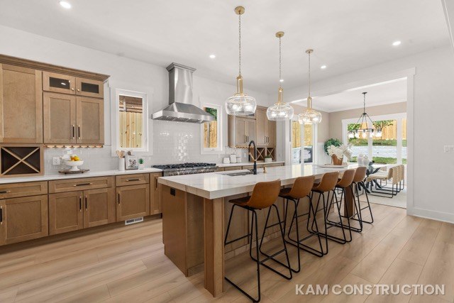 Kitchen with light wood cabinets and large island
