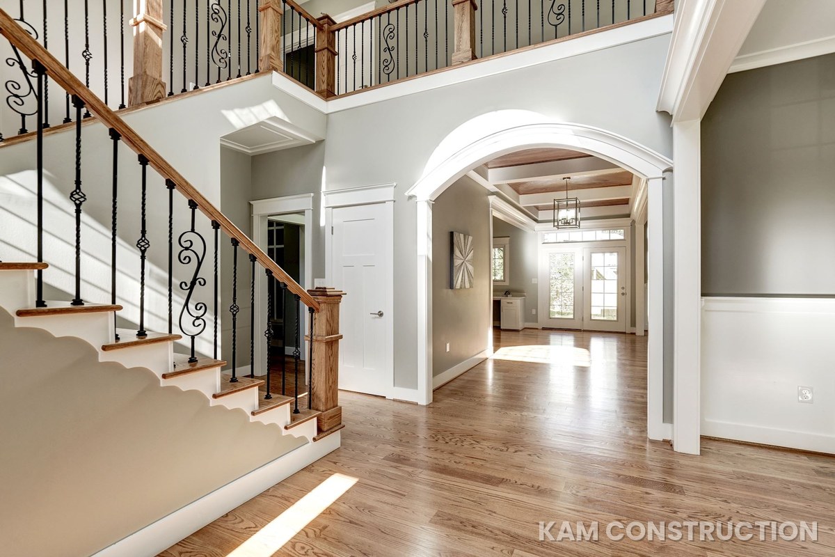 Two-story foyer with wrought iron staircase